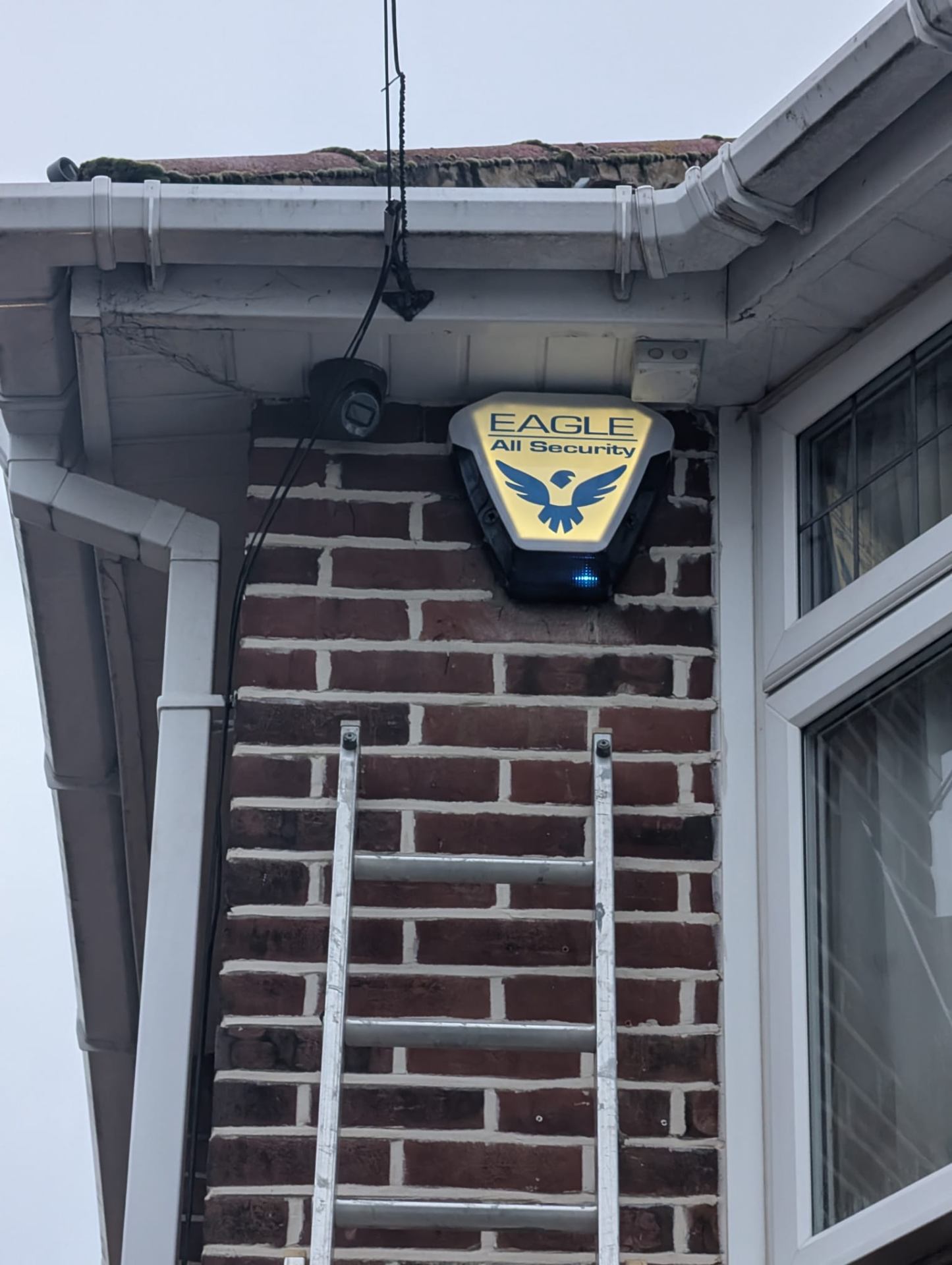 Eagle All Security branded alarm bell box being installed on a London property